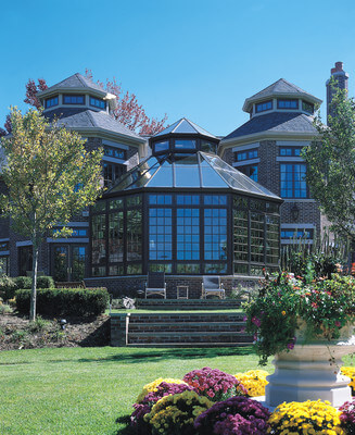 Conservatory sunroom with large glass panels and wood trim